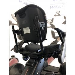 Zoomed in image of back of black wheelchair seat on a white background.