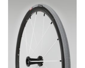 Close up view of a black tire on a grey background.