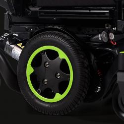 Close up image of black wheel with green rim of a powered wheelchair.