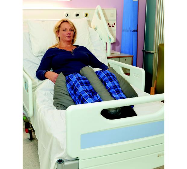 Lady in a bed showing the Symmetricare Therapeutic in Bed Positioning sitting up.