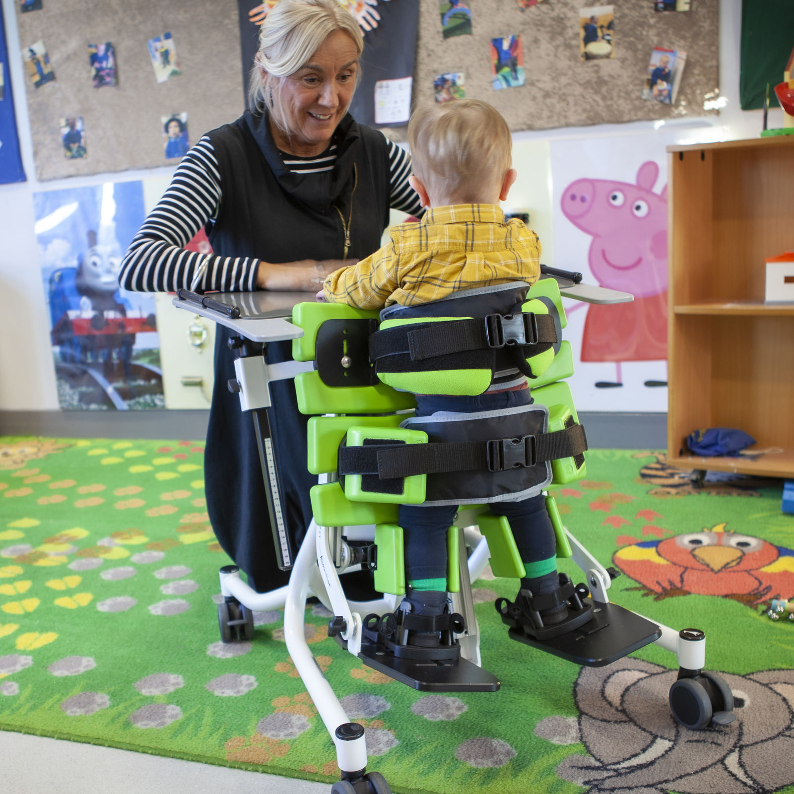 Jenx Multistander with 30-degree abduction enabling young boy to stand safely with hips supported for improved posture and weight bearing.