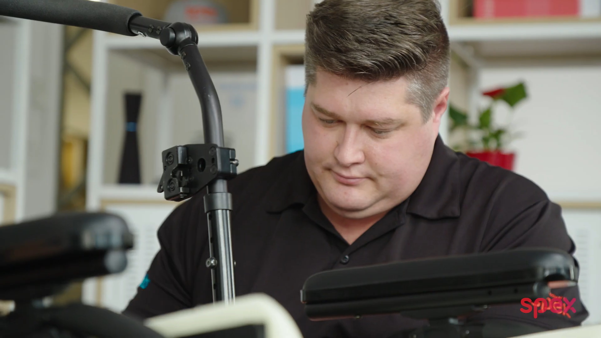 Medifab Consultant, William fixes the frame of a wheelchair , installing seating components to achieve functional posture.