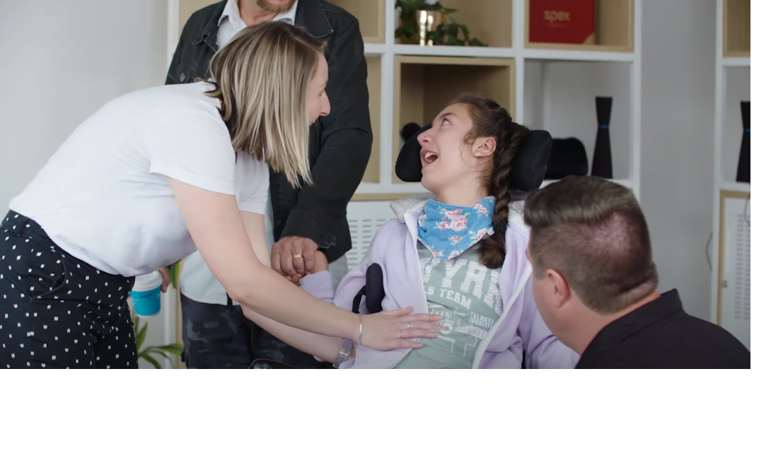 Girl gets a clinical evaluation for her wheelchair.