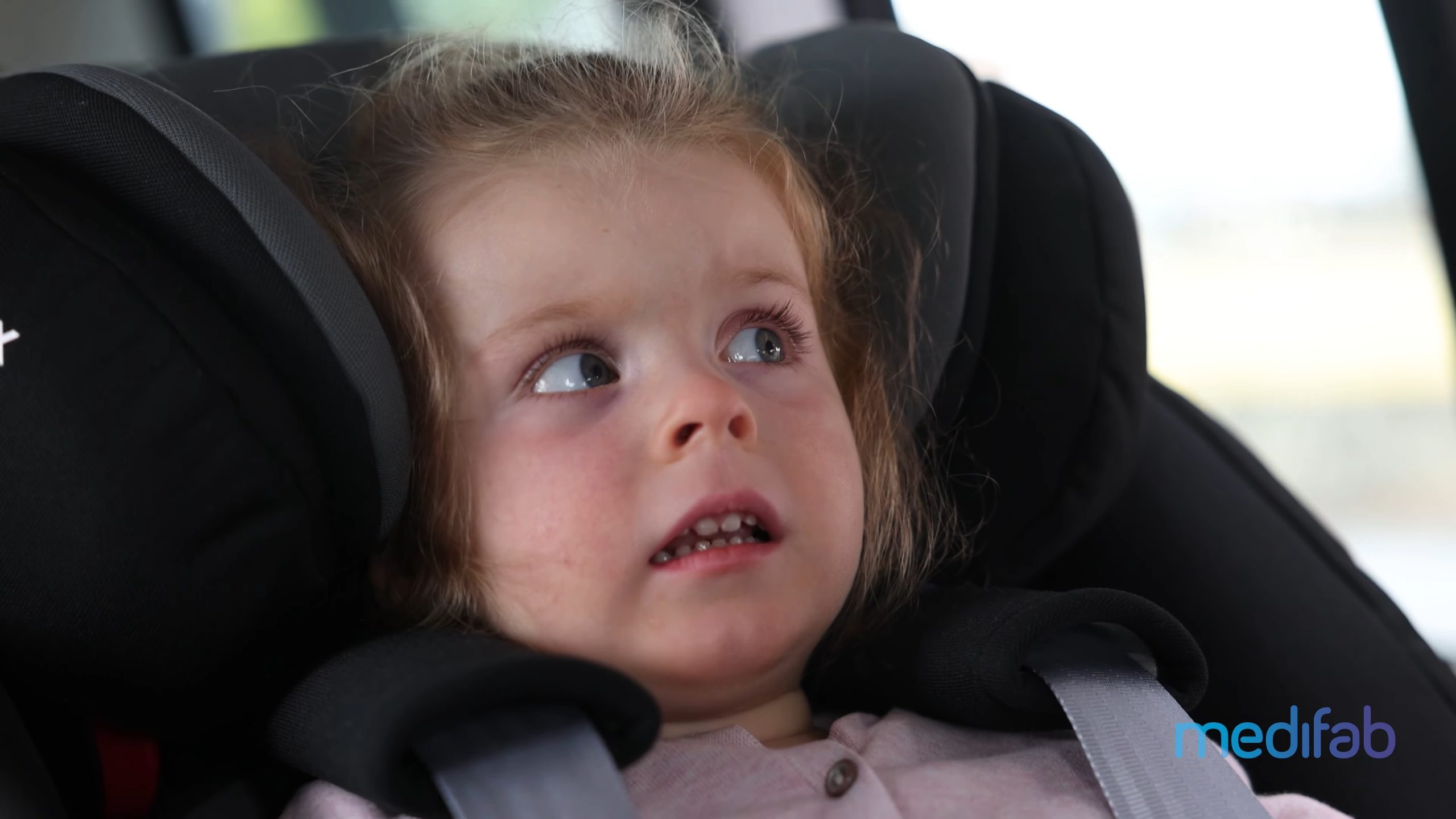 Child displaying use of the Starlight NXT Car Seat