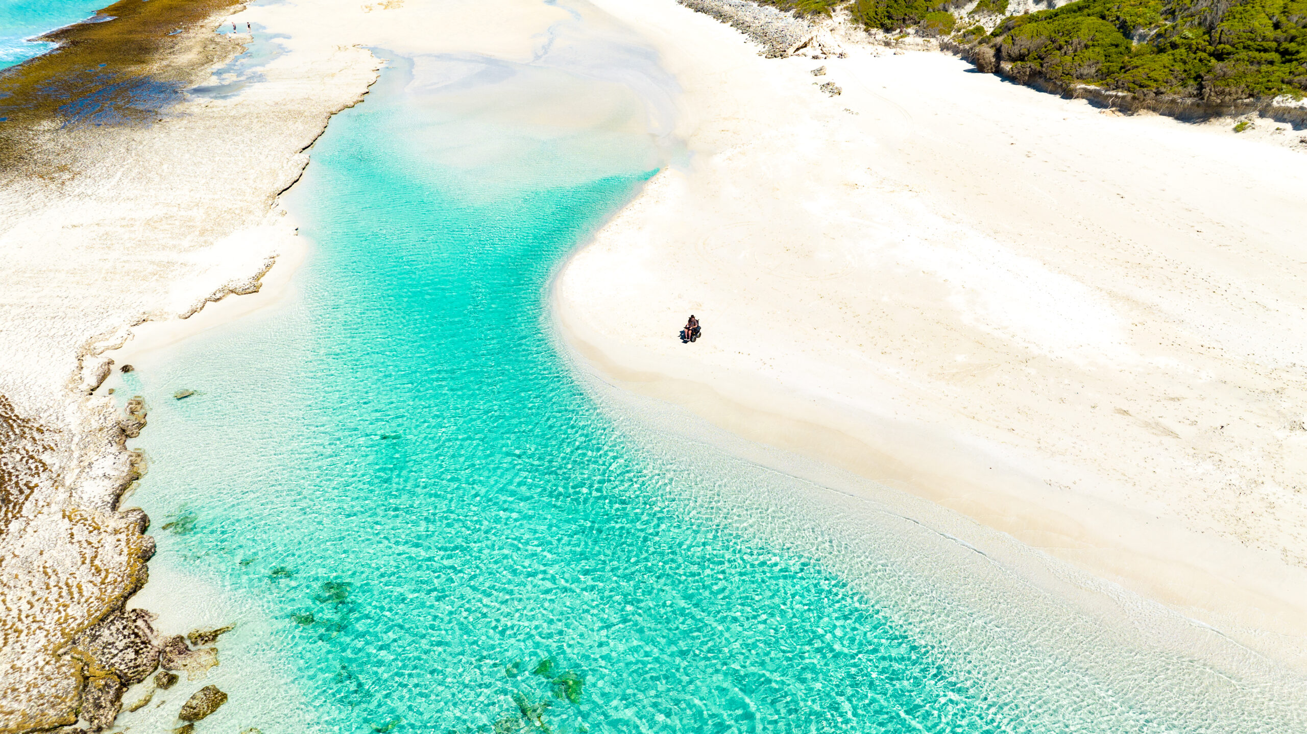 Drone image of man on the Magic Mobility X8 at the beach.