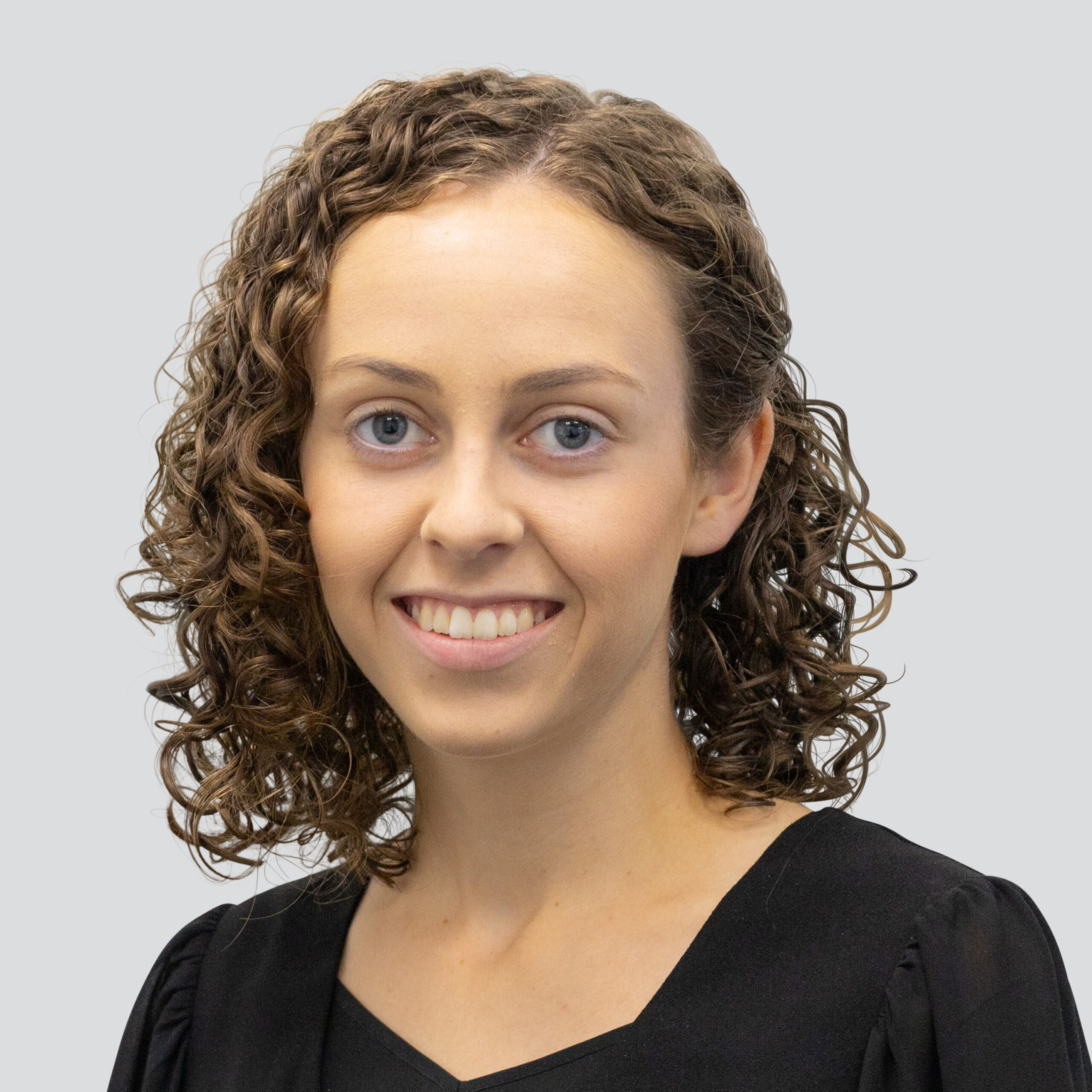 Corporate headshot of lady named Ivy Allison on a grey background.