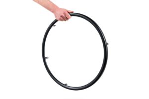 Singular wheelchair rim with a hand holding it at the top on a white background